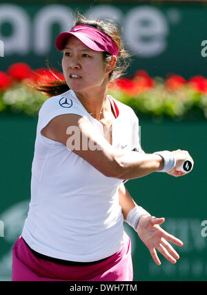 08 March, 2014: Na Li of China returns a shot against Jie Zheng of China during the BNP Paribas Open at Indian Wells Tennis Garden in Indian Wells CA. Stock Photo