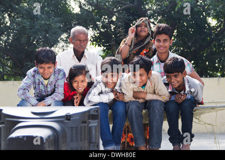 Indian Joint Family sitting and watching Television Stock Photo
