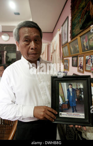 (140309) -- MEDAN, March. 9, 2014 (Xinhua) -- A family member shows a photo of Firman Chandra Siregar, one of missing Malaysia Airlines flight MH370 passengers who comes from Indonesia, in Medan, Indonesia, March 8, 2014. The Malaysia Airlines Flight MH370, a Boeing B777-200, lost communication and radar signal on its flight from Malaysia's capital Kuala Lumpur to Beijing on early Saturday morning. On board were 227 passengers from 14 countries, including 154 Chinese, and 12 Malaysian flight crew. (Xinhua/Gibran) Stock Photo