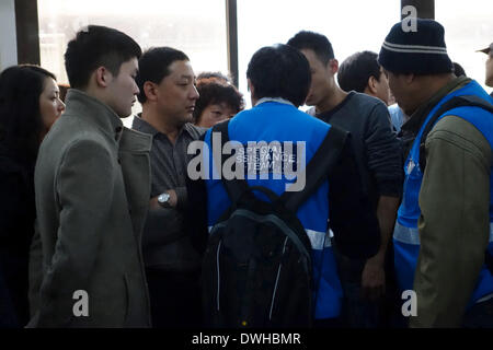 (140309) -- BEIJING, March 9, 2014 (Xinhua) -- A member of the special assistance team of the Malaysia Airlines brief the relatives of those on board the missing flight in Beijing, capital of China, March 9, 2014. The company gathered identity information of relatives of concerned passengers on early Sunday morning. The Malaysia Airlines Flight MH370, a Boeing B777-200, lost communication and radar signal on its flight from Malaysia's capital Kuala Lumpur to Beijing on early Saturday morning. On board were 227 passengers from 14 countries, including 154 Chinese, and 12 Malaysian flight crew. ( Stock Photo