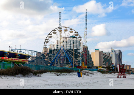 Ferris wheel and roller coaster in the Daytona Beach boardwalk amusement park on the beach. Stock Photo