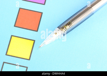 Closeup Mechanical pencil point to Yellow Checkbox on blue background. Stock Photo