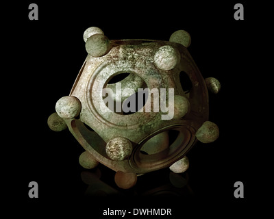 Ancient bronze Roman dodecahedron on a black background Stock Photo