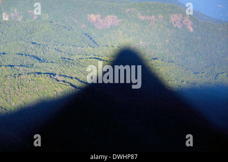 Early morning shadow of Adam's Peak (Sri Pada) cast over surrounding mountains Stock Photo