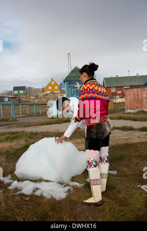 Greenland, Disko Bay, Saqqaq (aka Sarqaq or Solsiden). Couple, in traditional Greenlandic attire. Stock Photo