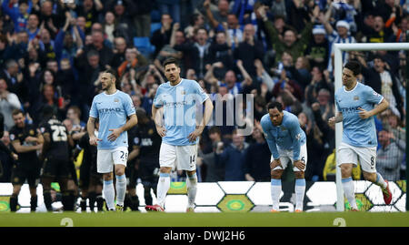 Manchester, Joleon Lescott and Samir Nasri of Manchester City (From L to R) react as players of Wigan celebrate their second goal during FA Cup quarterfinal match at Etihad Stadium in Manchester. 9th Mar, 2014. Martin Demichelis, Javi Garcia, Joleon Lescott and Samir Nasri of Manchester City (From L to R) react as players of Wigan celebrate their second goal during FA Cup quarterfinal match at Etihad Stadium in Manchester, Britain on March 9, 2014. Manchester City lost 1-2. © Wang Lili/Xinhua/Alamy Live News Stock Photo