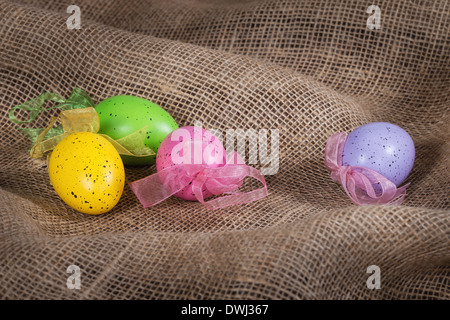 Colorful Easter eggs on burlap background Stock Photo
