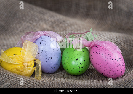 Colorful Easter eggs on burlap background Stock Photo
