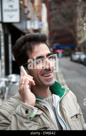 Man on Mobile on Public Street - London UK Stock Photo