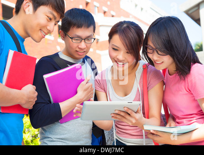 group of students discussing homework by using tablet at campus Stock Photo