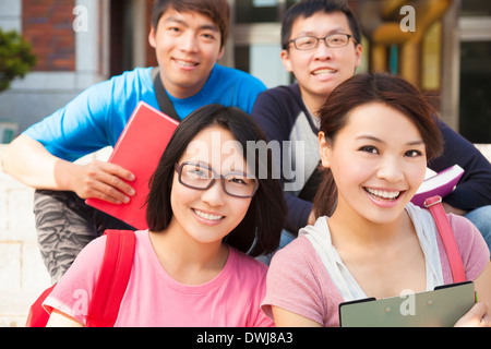 Aisan young students are sitting on stairs at campus Stock Photo