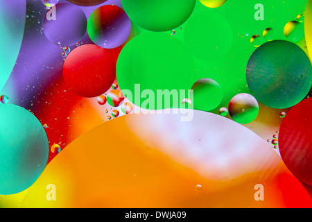 Oil drops in water on a coloured background Stock Photo