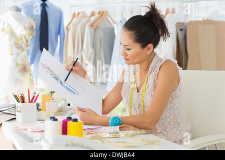 Female fashion designer working on her designs Stock Photo