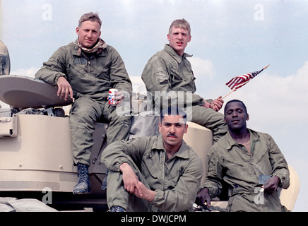 US Army soldiers sit on top of their Bradley Fighting Vehicle after the land battle begun crossing the border into Iraq during the Gulf War February 24, 1991 in Southern Iraq. Stock Photo