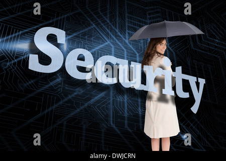 Businesswoman holding umbrella behind the word security Stock Photo