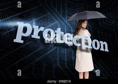 Businesswoman holding umbrella behind the word protection Stock Photo