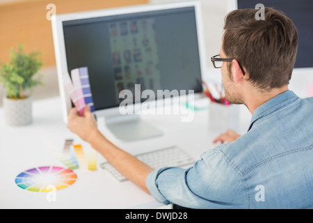 Casual male photo editor using computer Stock Photo