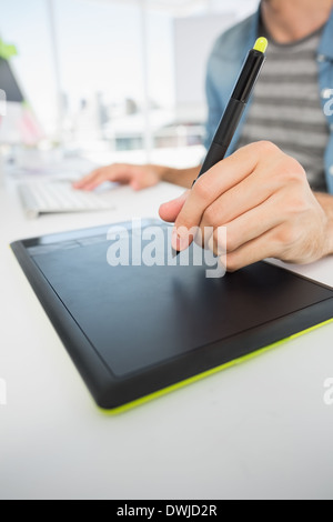 Casual male photo editor using graphics tablet Stock Photo