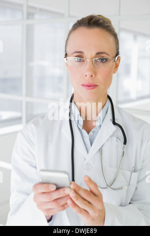 Portrait of a female doctor reading text message Stock Photo