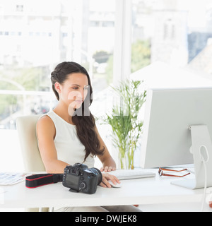 Beautiful photographer working at her desk Stock Photo