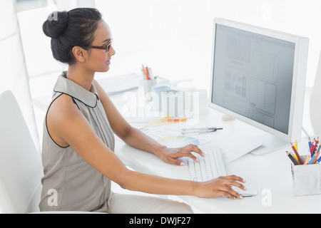 Designer working at her desk using computer Stock Photo
