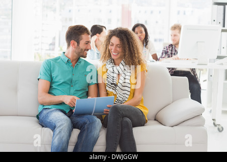 Smiling designers working together on the couch Stock Photo