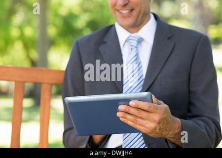 Midsection of businessman using digital tablet Stock Photo