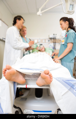 Doctor And Nurses Examining Patient's Medical Report Stock Photo