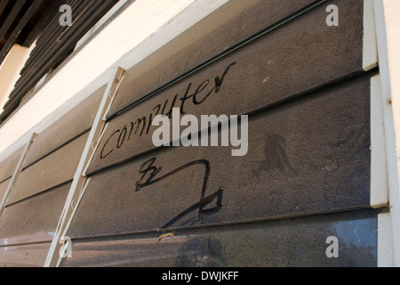 The word computer is written on a dusty louvered glass window at the University of Agriculture in Kampong Cham, Cambodia. Stock Photo