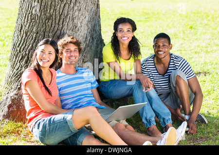 Happy students with laptop on campus Stock Photo