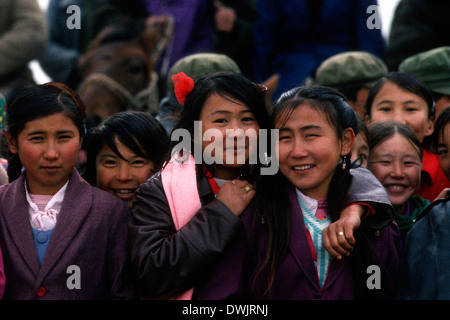 Kazakh boys and girls watching horse racing. These people literally live on horseback. Stock Photo