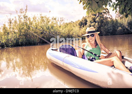 Beautiful woman girl fishing rod trolling in saltwater in a boat trolling  Stock Photo - Alamy