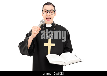 Male priest reading a prayer on microphone Stock Photo