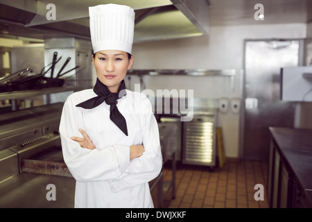 Portrait of confident female cook in kitchen Stock Photo