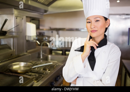Portrait of confident female cook in kitchen Stock Photo