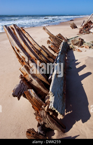 An old wooden shipwreck on the Skeleton Coast in Namibia Stock Photo