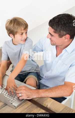 Boy and father using laptop Stock Photo