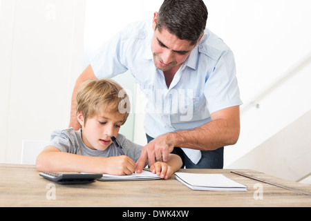 Father assisting son in homework Stock Photo