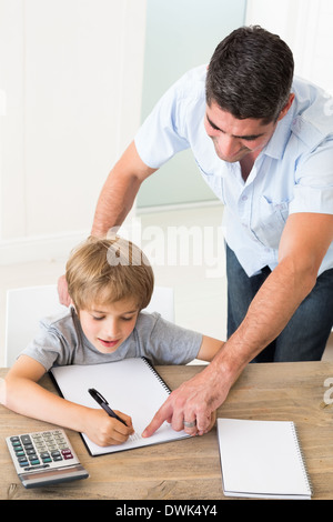 Father assisting boy in solving maths Stock Photo