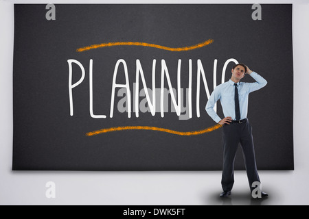 Businessman thinking against the word planning Stock Photo