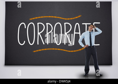Businessman thinking against the word corporate Stock Photo
