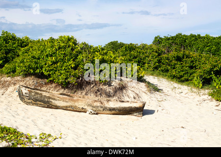 Handmade traditional canoe from a local fisherman left on the beach in Rolas Island. Quirimbas, Mozambique. Stock Photo