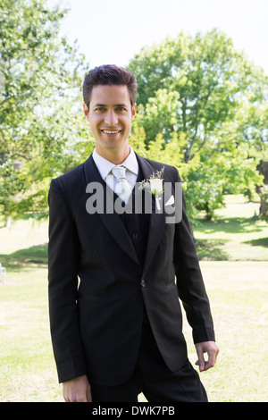 Groom in tuxedo standing at garden Stock Photo