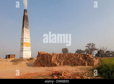 Rajasthan, India. Chimney Emitting Smoke from Underground Ovens Firing Bricks. Stock Photo