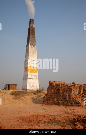 Rajasthan, India. Chimney Emitting Smoke from Underground Ovens Firing Bricks. Stock Photo