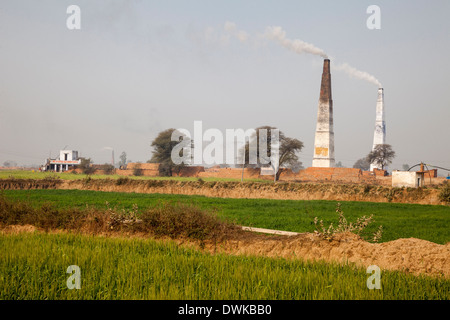 Rajasthan, India. Chimney Emitting Smoke from Underground Ovens Firing Bricks. Stock Photo