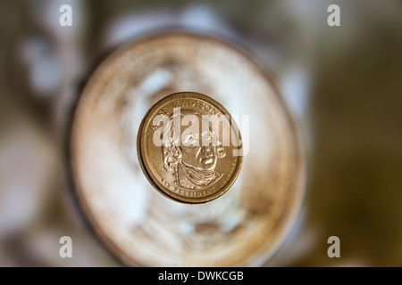 A James Madison U.S. Dollar coin with a Ulysses S Grant dollar coin on a computer screen as a background Stock Photo