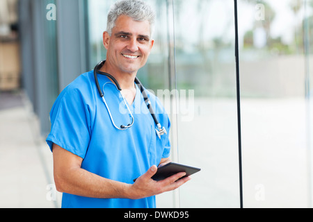 happy male medical doctor using tablet computer in hospital Stock Photo