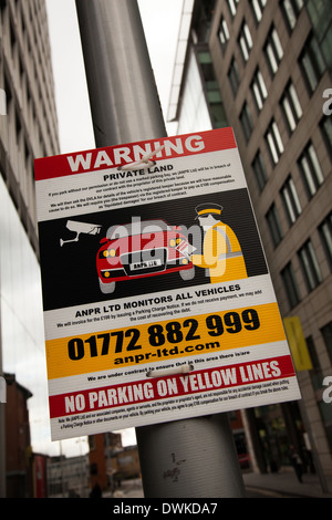 Warning private land. No parking on yellow lines, private parking enforcement in Manchester, UK Stock Photo