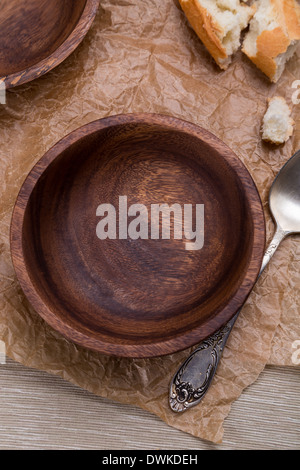 empty wooden bowl for soup on crushed brown paper Stock Photo